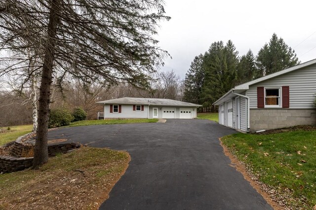 view of front of property with a garage and a front lawn