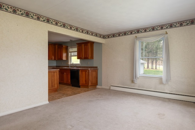 kitchen with baseboard heating, a wealth of natural light, pendant lighting, and black dishwasher