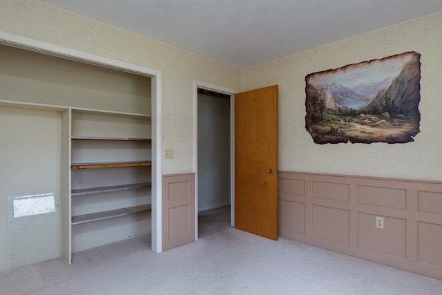 unfurnished bedroom featuring light carpet