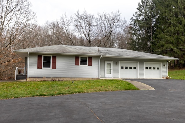 view of front of property featuring a garage and a front lawn