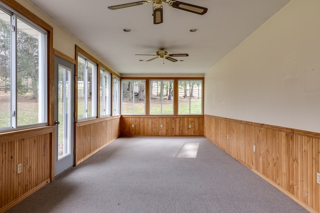 unfurnished sunroom featuring plenty of natural light and ceiling fan