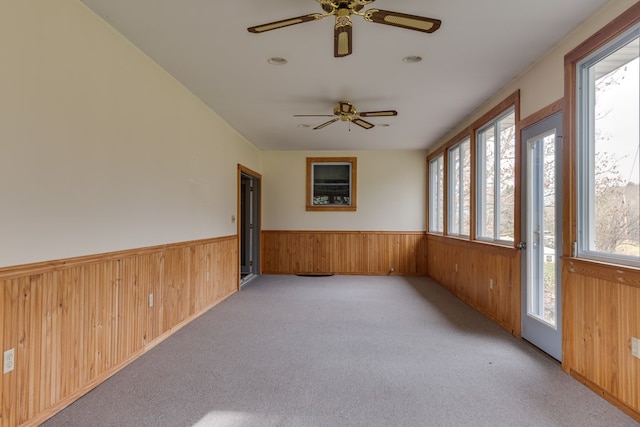 unfurnished sunroom featuring ceiling fan