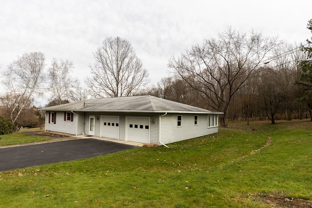 view of side of property with a yard and a garage