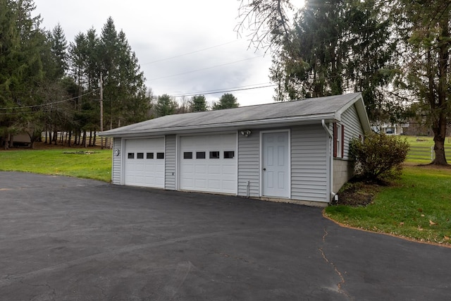 garage featuring a lawn