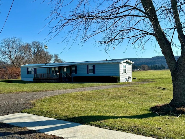 view of front of home featuring covered porch and a front lawn