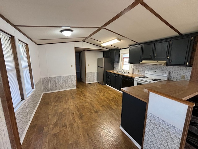 kitchen with kitchen peninsula, vaulted ceiling, white electric range, dark hardwood / wood-style floors, and stainless steel refrigerator