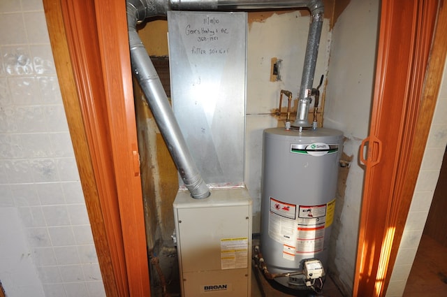 utility room featuring water heater