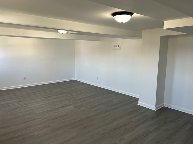 empty room featuring dark hardwood / wood-style flooring