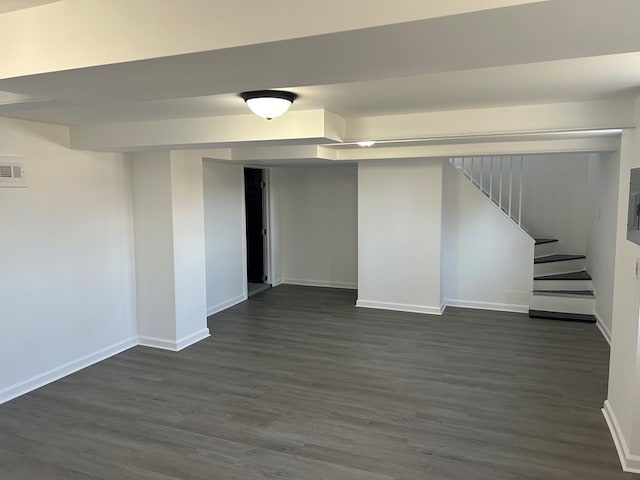 basement featuring dark hardwood / wood-style flooring