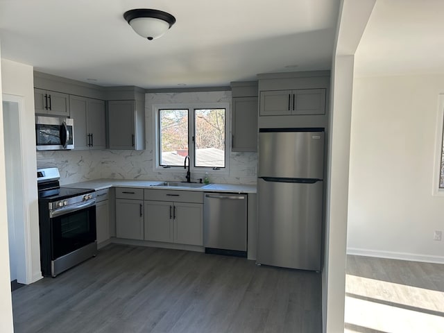 kitchen featuring gray cabinetry, light hardwood / wood-style floors, sink, and appliances with stainless steel finishes