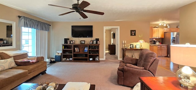 living room with light colored carpet and ceiling fan