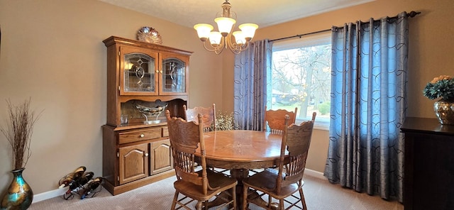 dining area featuring a chandelier and light colored carpet