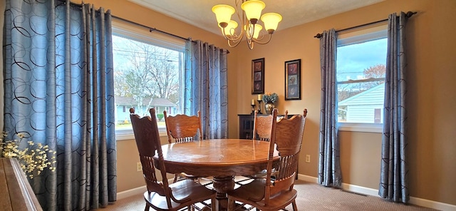 dining area featuring carpet, a textured ceiling, a wealth of natural light, and an inviting chandelier