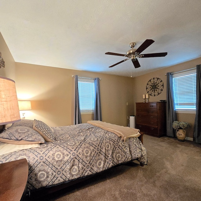 bedroom featuring carpet, a textured ceiling, and ceiling fan