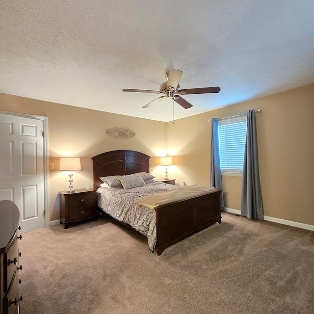 bedroom with a textured ceiling, carpet floors, and ceiling fan