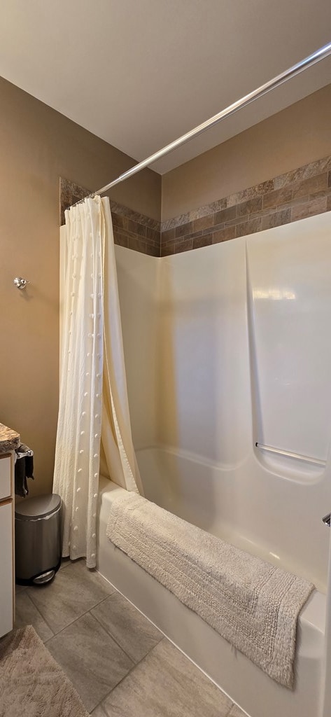 bathroom with tile patterned floors, shower / bath combination with curtain, and vanity