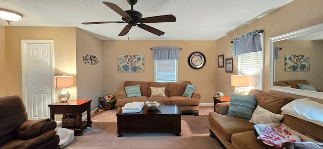 carpeted living room with ceiling fan