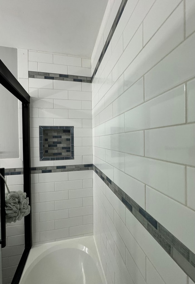 bathroom with bathing tub / shower combination