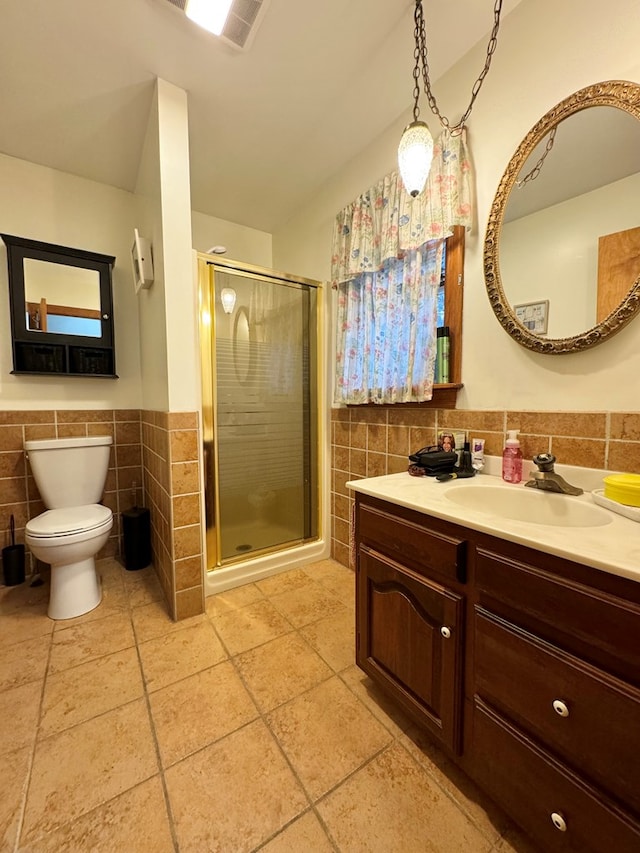 bathroom featuring walk in shower, vanity, toilet, and tile walls