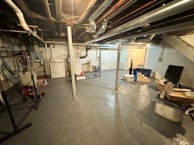 basement featuring sink and washer / dryer