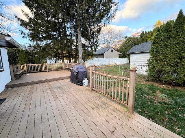 deck featuring a lawn and a grill