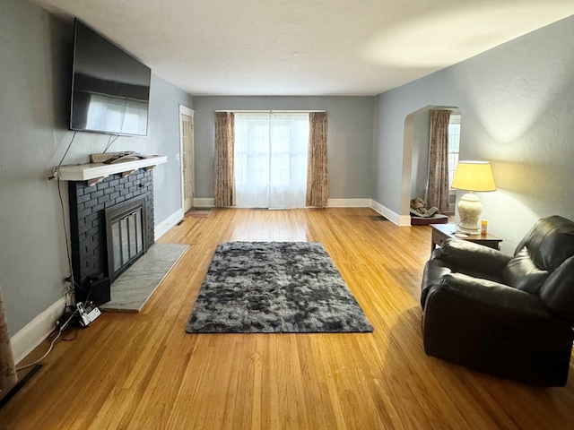 living room with a fireplace and hardwood / wood-style floors