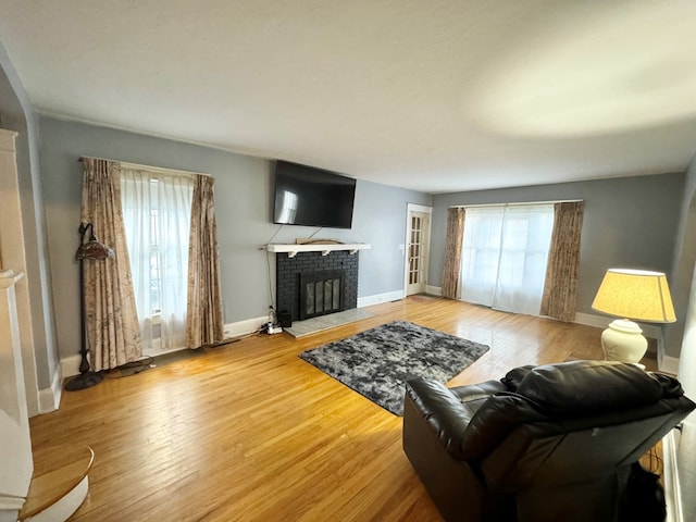 living room with hardwood / wood-style flooring and a fireplace