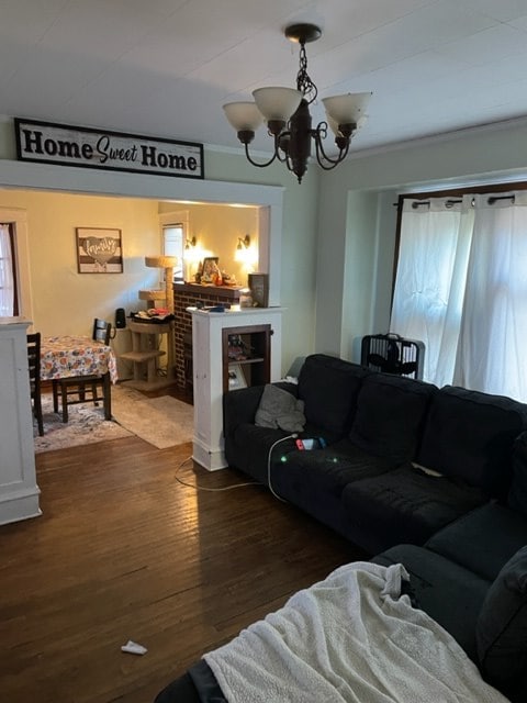 living room with a notable chandelier and dark hardwood / wood-style flooring