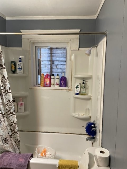 bathroom with shower / tub combo with curtain and ornamental molding