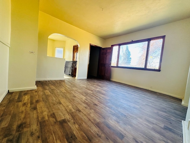 empty room featuring dark wood-type flooring