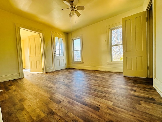 unfurnished room featuring ceiling fan and dark hardwood / wood-style floors