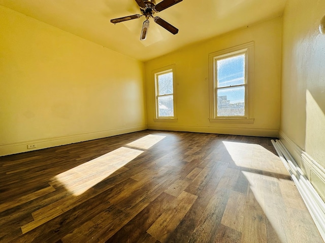 unfurnished room featuring ceiling fan and dark hardwood / wood-style flooring