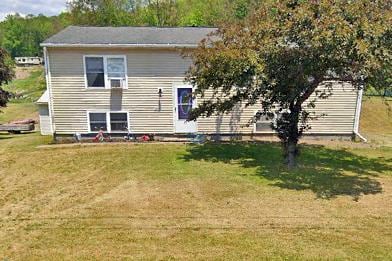 back of house featuring a yard