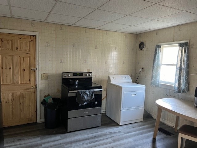 clothes washing area featuring wood-type flooring and washer / dryer