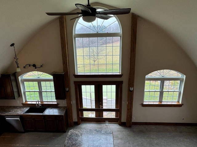 interior space featuring ceiling fan, sink, french doors, and a towering ceiling