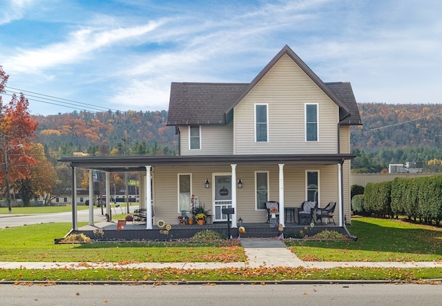 view of front of house with covered porch and a front yard