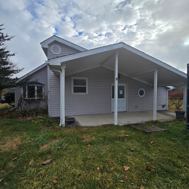 view of property exterior with a lawn and a patio