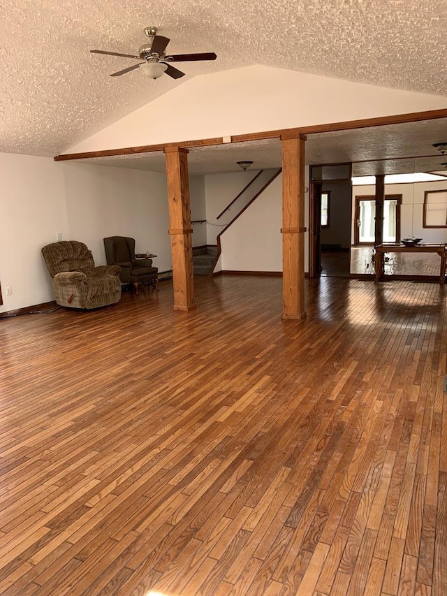 basement featuring ceiling fan, hardwood / wood-style floors, and a textured ceiling