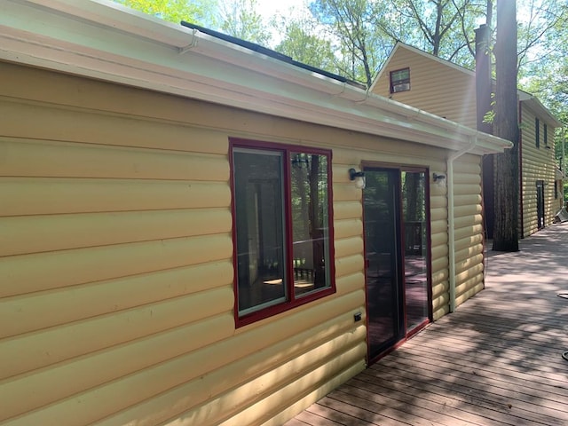 view of home's exterior with a wooden deck