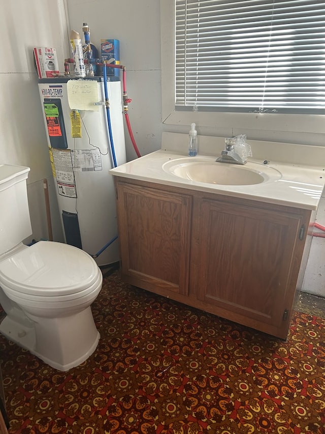 bathroom with vanity, toilet, and water heater