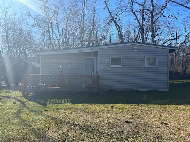 exterior space featuring a wooden deck and a yard