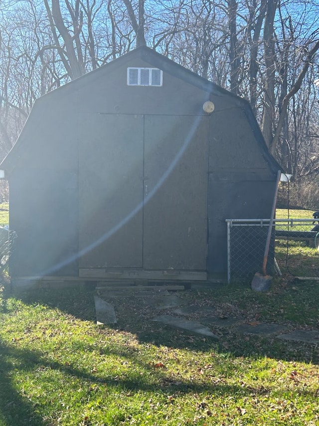 view of outbuilding with a yard