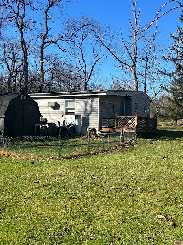 view of front of property with a wooden deck and a front yard