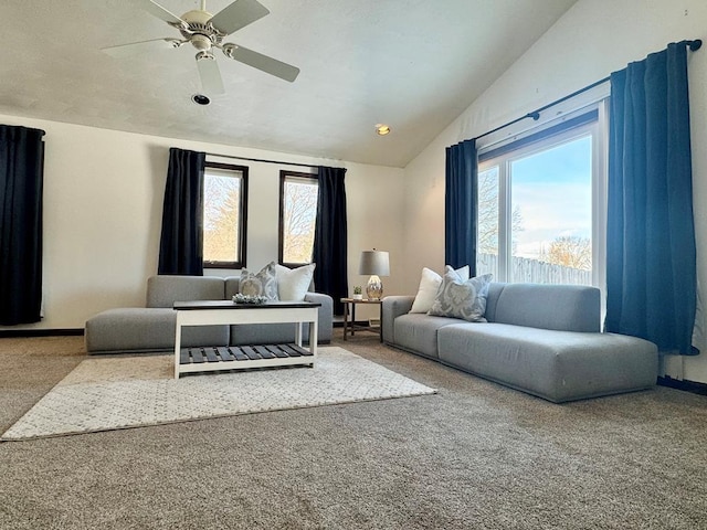 living room with a wealth of natural light, carpet floors, and vaulted ceiling