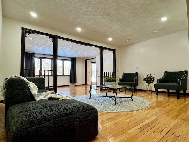 living room with wood-type flooring and a textured ceiling