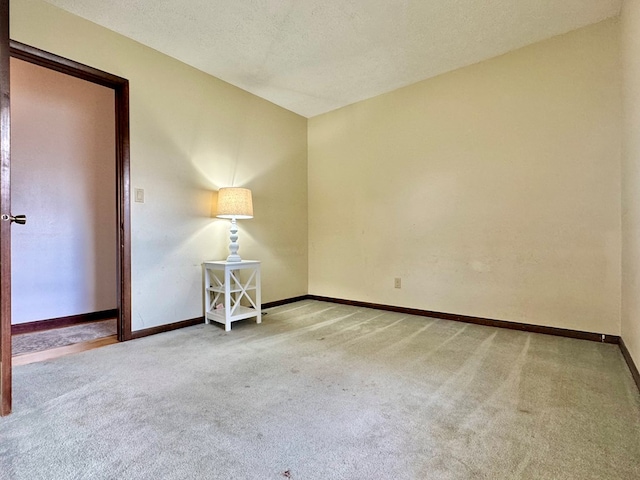 unfurnished room featuring a textured ceiling and carpet flooring