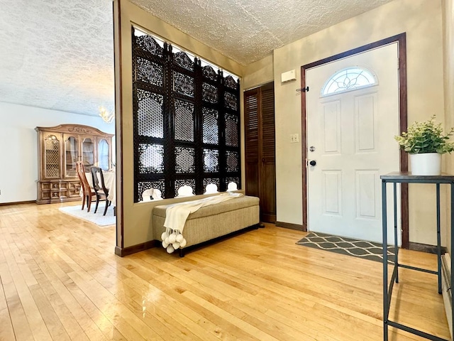 entrance foyer with a textured ceiling and light wood-type flooring