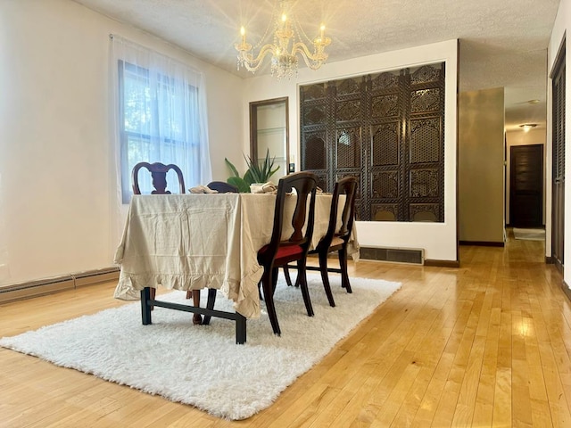 miscellaneous room with hardwood / wood-style floors, a notable chandelier, and a textured ceiling