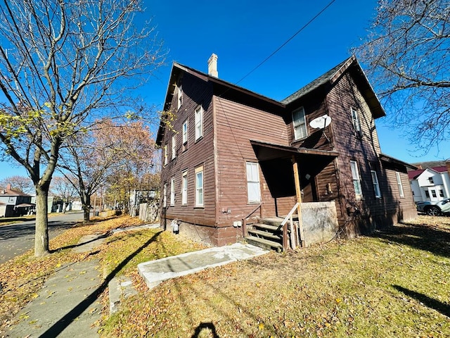 view of side of home featuring a yard