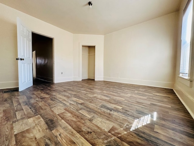 unfurnished bedroom with hardwood / wood-style flooring and a closet